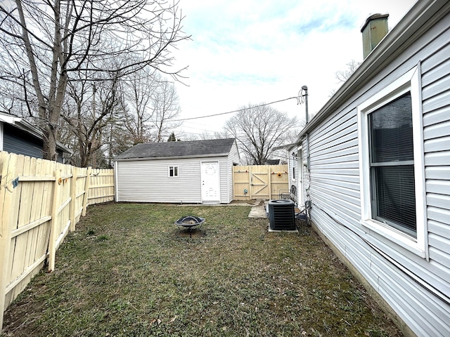 2322 Mecca Rd, Columbus, OH 43224 - view of yard featuring an outdoor fire pit, an outbuilding, and central AC