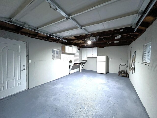 2322 Mecca Rd, Columbus, OH 43224 - garage featuring freestanding refrigerator and a garage door opener
