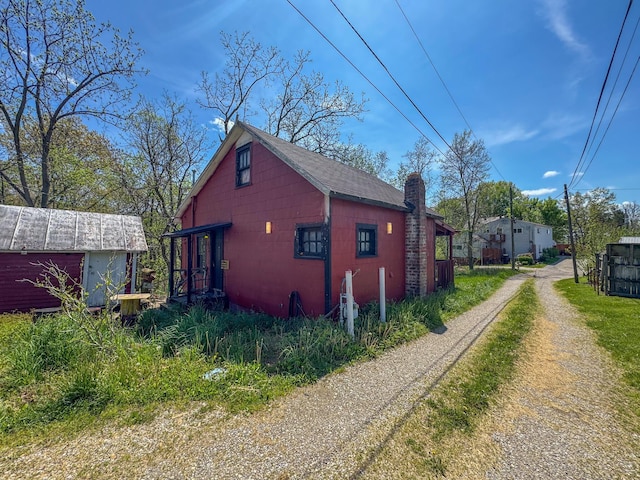 view of property exterior featuring an outbuilding and concrete block siding