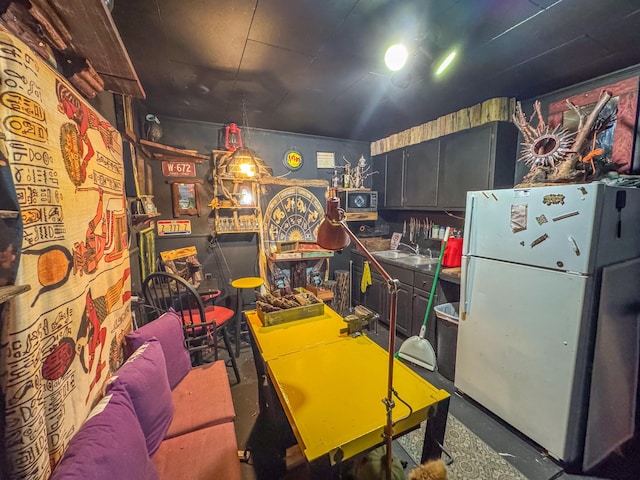 recreation room featuring concrete flooring and a sink