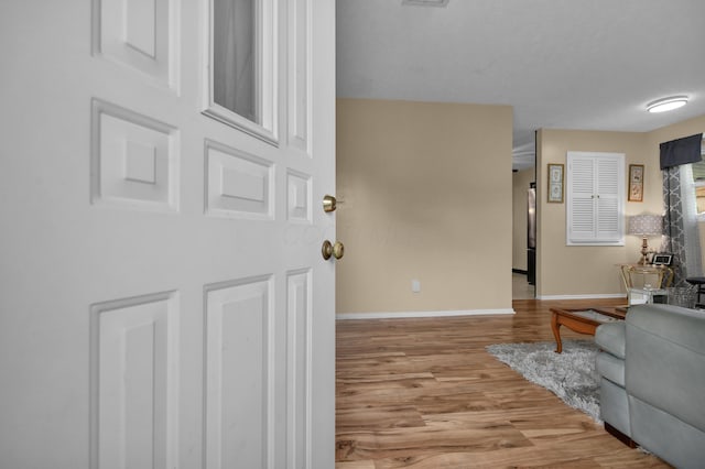 living room featuring light wood-type flooring and baseboards