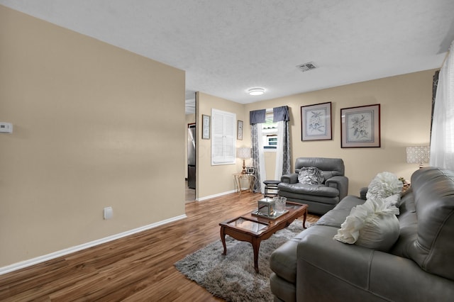 living area with wood finished floors and baseboards
