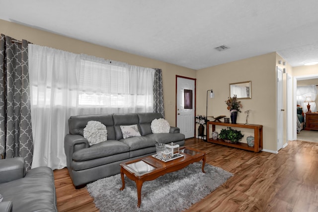 living room featuring wood finished floors and baseboards