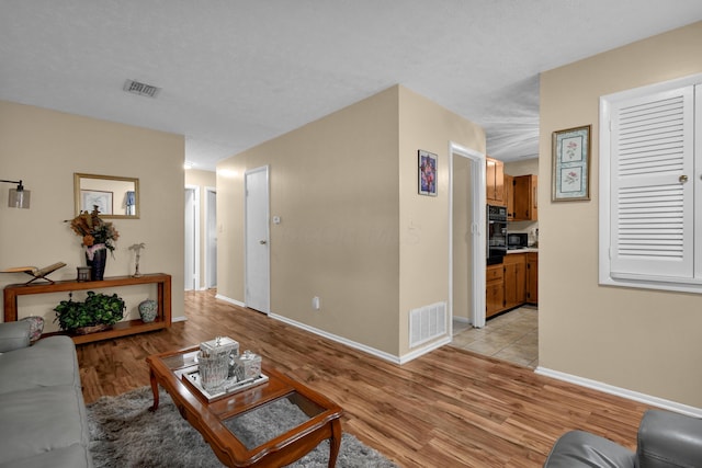 living room with light wood-style floors and baseboards