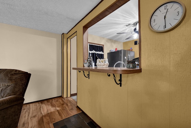 corridor with wood finished floors and baseboards