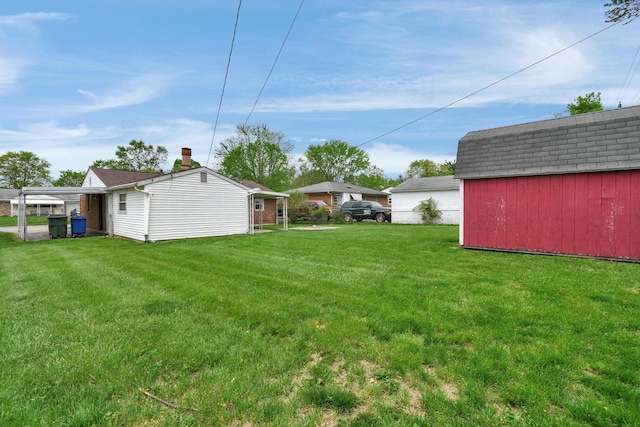 view of grassy yard featuring an outdoor structure and a storage shed