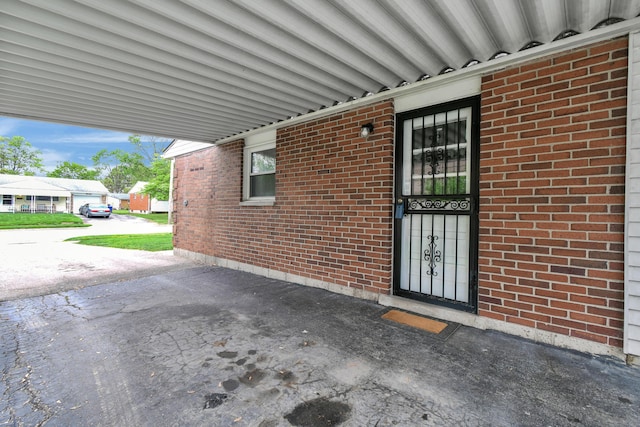 doorway to property with brick siding