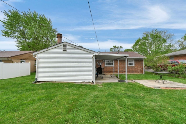 rear view of property with a patio area and brick siding