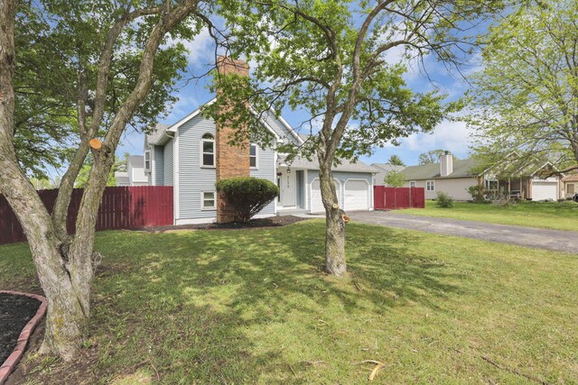 7170 Daugherty Dr, Reynoldsburg, OH 43068 - traditional home with driveway, a garage, and a chimney