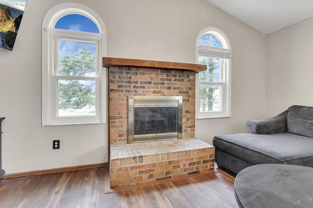 7170 Daugherty Dr, Reynoldsburg, OH 43068 - living room featuring wood finished floors, a fireplace, baseboards, and vaulted ceiling