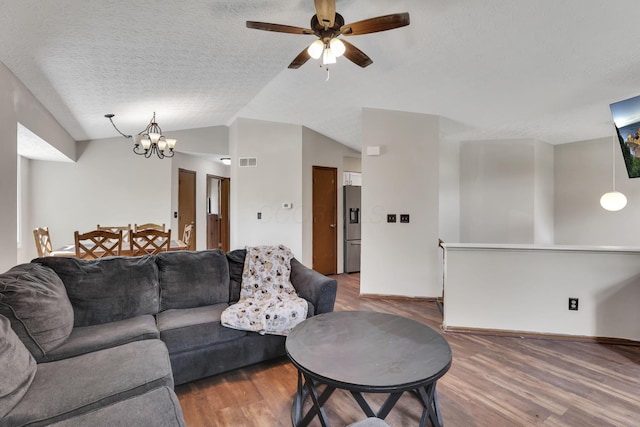 7170 Daugherty Dr, Reynoldsburg, OH 43068 - living area with vaulted ceiling, wood finished floors, a textured ceiling, a ceiling fan, and a chandelier