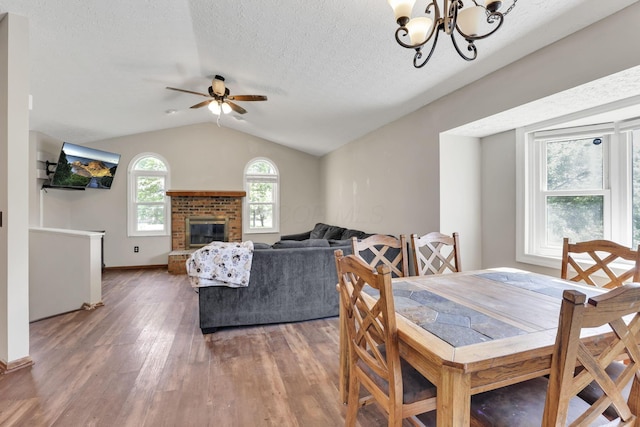 7170 Daugherty Dr, Reynoldsburg, OH 43068 - dining area featuring lofted ceiling, wood finished floors, ceiling fan, a textured ceiling, and a chandelier