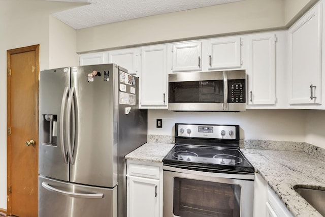 7170 Daugherty Dr, Reynoldsburg, OH 43068 - kitchen featuring stainless steel appliances, white cabinetry, and light stone counters