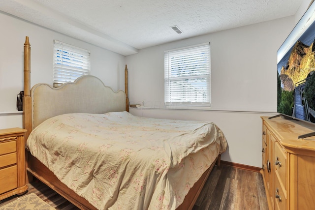 7170 Daugherty Dr, Reynoldsburg, OH 43068 - bedroom featuring wood finished floors, multiple windows, a textured ceiling, and baseboards