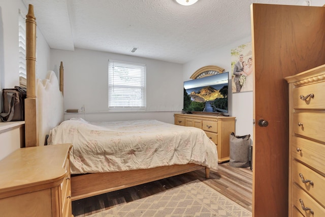 7170 Daugherty Dr, Reynoldsburg, OH 43068 - bedroom with wood finished floors and a textured ceiling