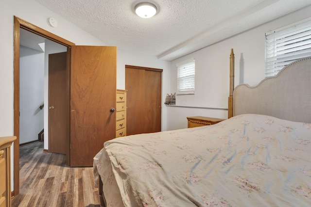 7170 Daugherty Dr, Reynoldsburg, OH 43068 - bedroom with wood finished floors, a closet, and a textured ceiling