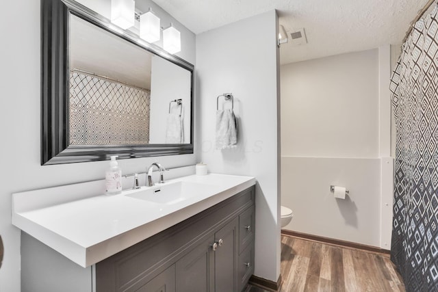 7170 Daugherty Dr, Reynoldsburg, OH 43068 - full bath with wood finished floors, toilet, vanity, and baseboards
