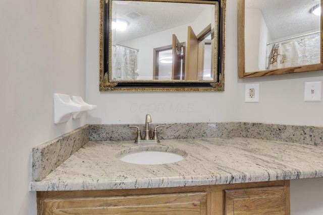 7170 Daugherty Dr, Reynoldsburg, OH 43068 - bathroom with a textured ceiling and vanity