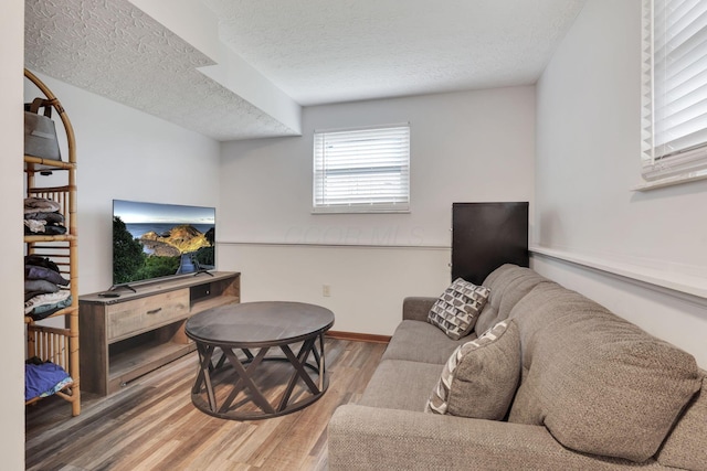 7170 Daugherty Dr, Reynoldsburg, OH 43068 - living area with wood finished floors, a textured ceiling, and baseboards