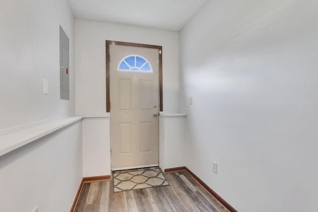 7170 Daugherty Dr, Reynoldsburg, OH 43068 - doorway to outside with wood finished floors, electric panel, and baseboards