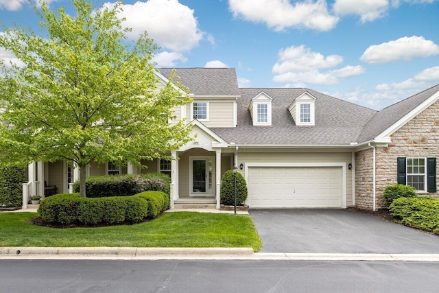 6575 Wensley Ct, Westerville, OH 43082 - view of front facade featuring stone siding, asphalt driveway, a shingled roof, and a front yard