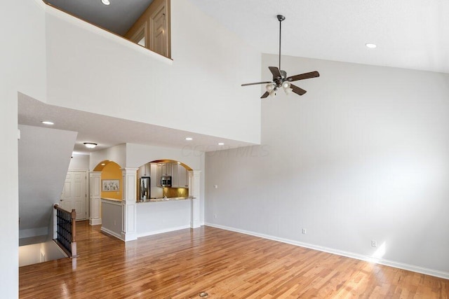 6575 Wensley Ct, Westerville, OH 43082 - unfurnished living room with ceiling fan, high vaulted ceiling, ornate columns, light wood-style flooring, and recessed lighting