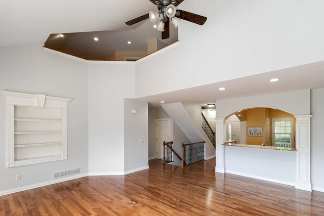 6575 Wensley Ct, Westerville, OH 43082 - unfurnished living room with high vaulted ceiling, ceiling fan, wood finished floors, arched walkways, and recessed lighting