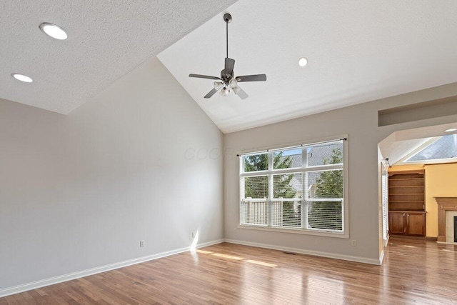 6575 Wensley Ct, Westerville, OH 43082 - unfurnished room with lofted ceiling, wood finished floors, arched walkways, ceiling fan, and baseboards