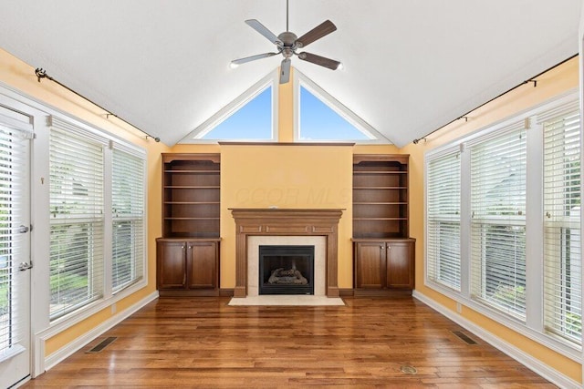 6575 Wensley Ct, Westerville, OH 43082 - unfurnished living room with wood finished floors, a fireplace with flush hearth, vaulted ceiling, and healthy amount of natural light