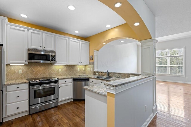 6575 Wensley Ct, Westerville, OH 43082 - kitchen with stainless steel appliances, a sink, white cabinets, backsplash, and dark wood-style floors