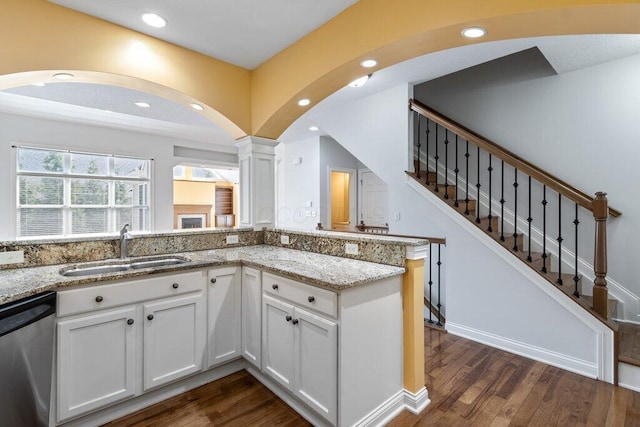 6575 Wensley Ct, Westerville, OH 43082 - kitchen with a sink, stainless steel dishwasher, dark wood-style floors, light stone counters, and white cabinets