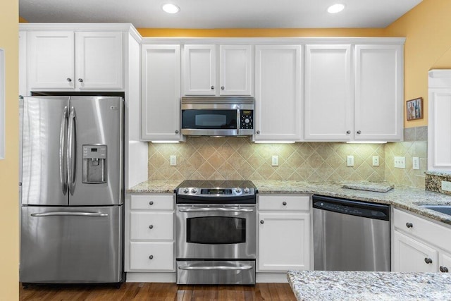 6575 Wensley Ct, Westerville, OH 43082 - kitchen with stainless steel appliances, white cabinetry, dark wood finished floors, and recessed lighting