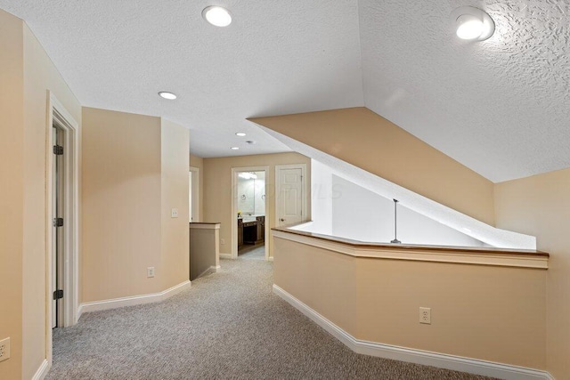 6575 Wensley Ct, Westerville, OH 43082 - corridor with light colored carpet, baseboards, a textured ceiling, recessed lighting, and lofted ceiling