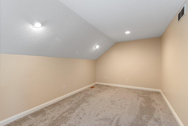 6575 Wensley Ct, Westerville, OH 43082 - additional living space featuring light colored carpet, lofted ceiling, baseboards, and recessed lighting