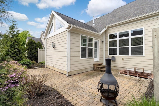6575 Wensley Ct, Westerville, OH 43082 - back of property with an outdoor fire pit, a patio, and roof with shingles