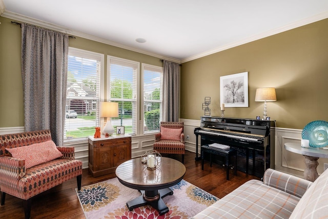 living area featuring ornamental molding, wood finished floors, a wainscoted wall, and baseboard heating