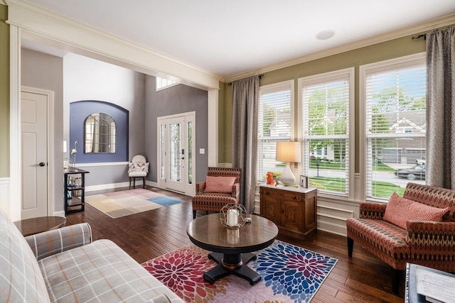 sitting room featuring crown molding, dark wood-style floors, and baseboards