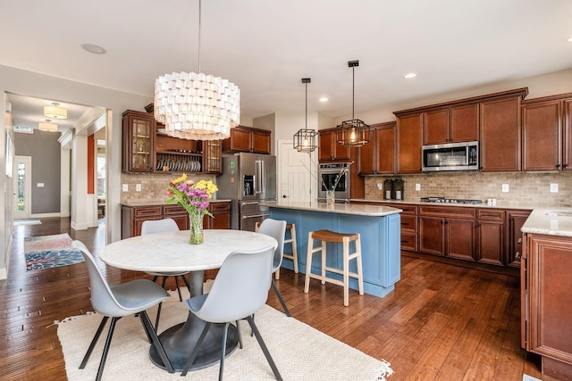 dining space featuring dark wood-type flooring, recessed lighting, baseboards, and a chandelier