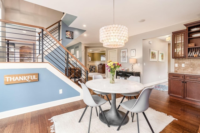 dining space with baseboards, stairs, dark wood-style flooring, a chandelier, and recessed lighting