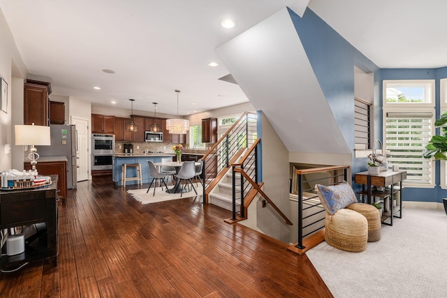 living room with dark wood-style floors, stairs, recessed lighting, and baseboards