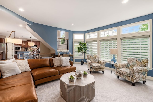 living area with recessed lighting and light colored carpet