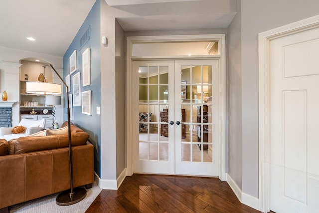 doorway with baseboards, dark wood-style flooring, and french doors