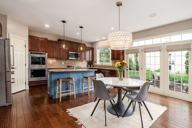 dining space featuring recessed lighting, dark wood-style flooring, and a chandelier