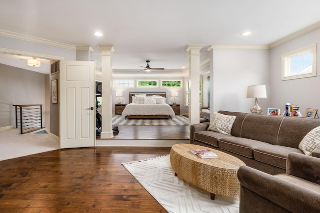 living area with decorative columns, ornamental molding, a ceiling fan, healthy amount of natural light, and hardwood / wood-style floors