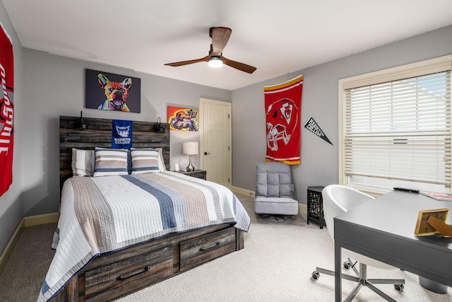 bedroom with carpet flooring, a desk, baseboards, and a ceiling fan