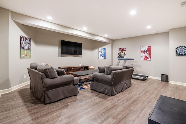 living room featuring recessed lighting, baseboards, and wood finished floors