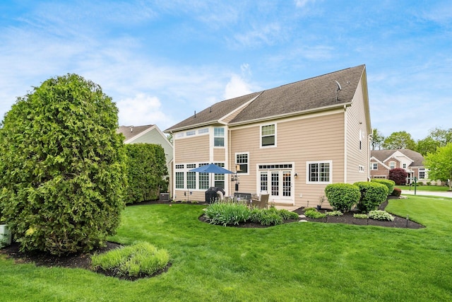 rear view of house with a yard, a patio, and central AC unit