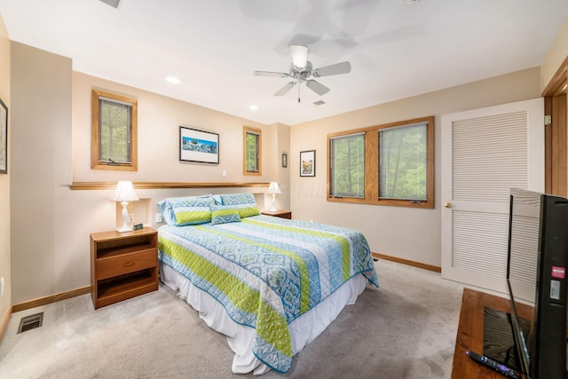 carpeted bedroom featuring baseboards, recessed lighting, and a ceiling fan