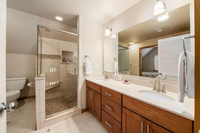 full bathroom featuring toilet, a shower stall, double vanity, and tile patterned flooring