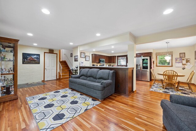 living room featuring light wood-type flooring, stairway, recessed lighting, and baseboards